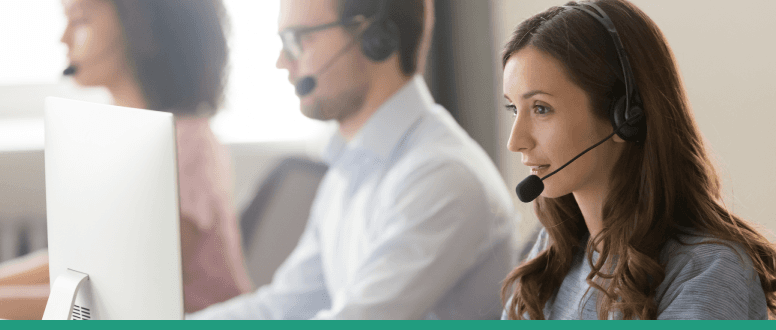 Call centre adviser with headset talking to customer