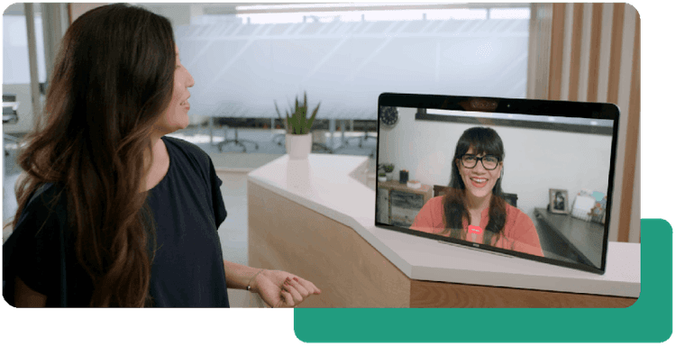 Screen in office reception showing receptionist